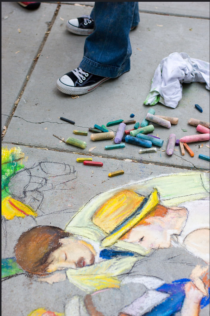 Chalk pastels piled beside the outlined early stage of Dana Ellyn's sidewalk recreation of Luncheon of the Boating Party